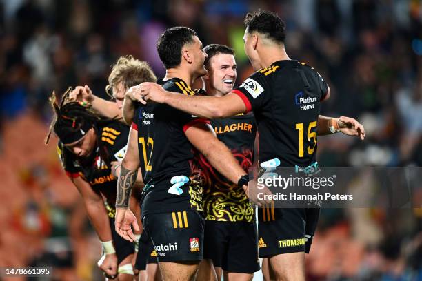 Bryn Gatland, Rameka Poihipi and Shaun Stevenson of the Chiefs celebrate winning the round six Super Rugby Pacific match between Chiefs and Blues at...