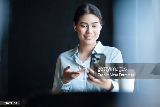 intelligent virtual connections technologies can drive your business to success. businesswoman answering or conference call with her business partner on a smartphone in an office space. - phone interview event stock pictures, royalty-free photos & images