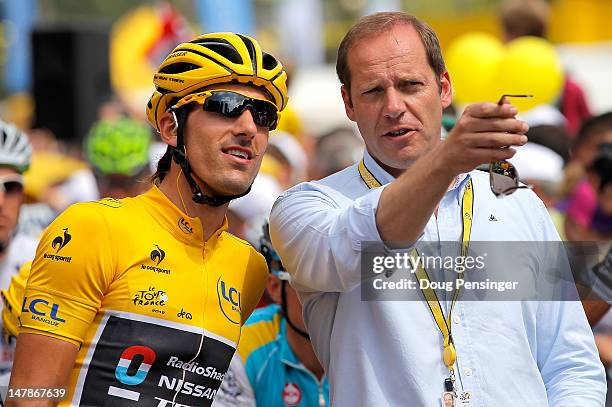 Fabian Cancellara of Switzerland riding for Radioshack-Nissan in the race leader's yellow jersey talks with Christian Prudhomme, Director of the Tour...