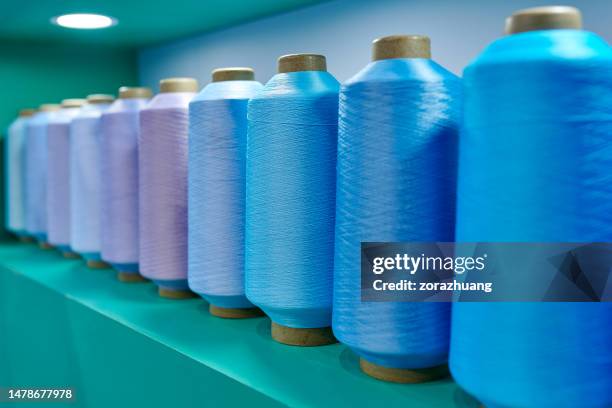 side view of blue & purple color series yarn spindles - chlorine cylinder stock pictures, royalty-free photos & images