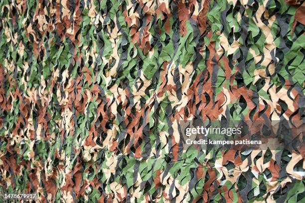 camouflage netting background - military patch stock pictures, royalty-free photos & images