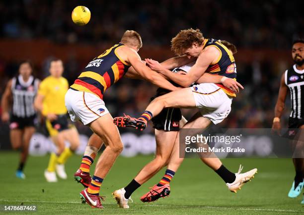 Max Michalanney of the Crows is taken out by Todd Marshall of Port Adelaide in front of Nick Murray of the Crows during the round three AFL match...