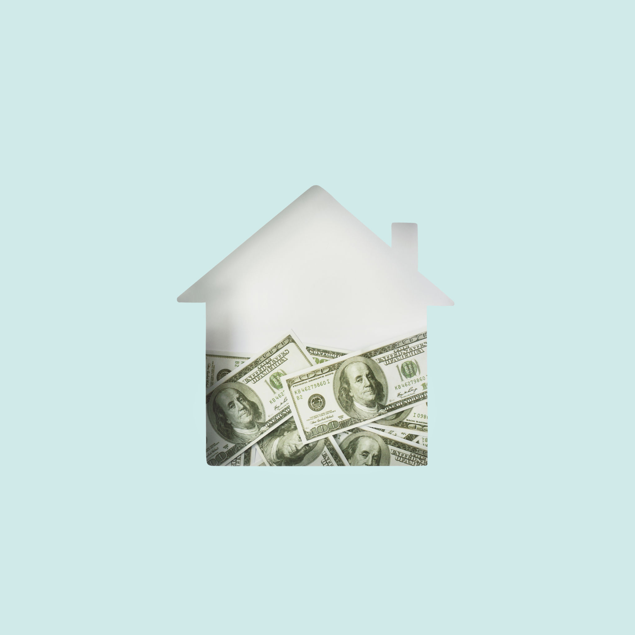 House shape cut out half filled with dollar bills inside. Minimal mortgage, house, savings, insurance concept. Flat lay House shape cut out half filled with dollar bills inside. Minimal mortgage, house, savings, insurance concept. Flat lay