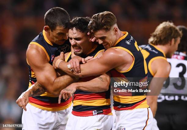 Izak Rankine of the Crows celebrates a goal with Taylor Walker of the Crows and Ben Keays of the Crows during the round three AFL match between Port...