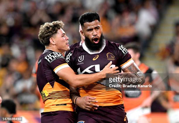 Payne Haas of the Broncos celebrates with team mate Reece Walsh of the Broncos after scoring a try during the round five NRL match between Brisbane...