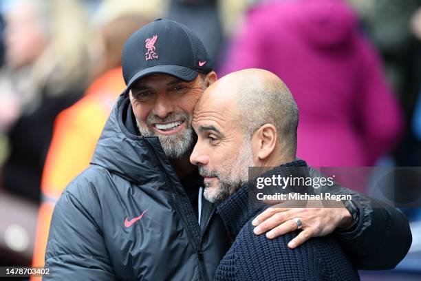 Juergen Klopp, Manager of Liverpool, embraces Pep Guardiola, Manager of Manchester City, prior to the Premier League match between Manchester City...