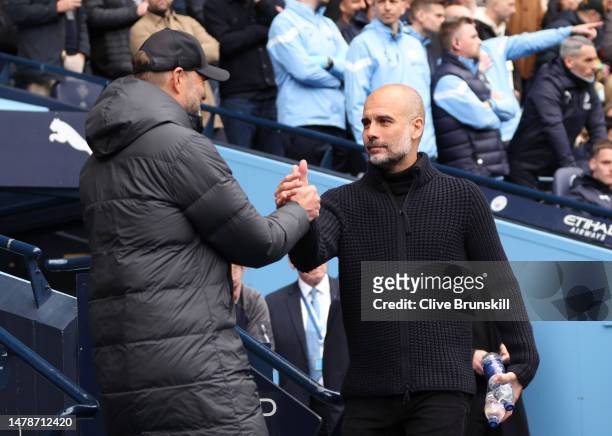 Juergen Klopp, Manager of Liverpool, embraces Pep Guardiola, Manager of Manchester City, prior to the Premier League match between Manchester City...