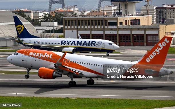 An easyJet aircraft moves past a Ryanair airplane while taking off for London at Humberto Delgado International Airport during the first of a...