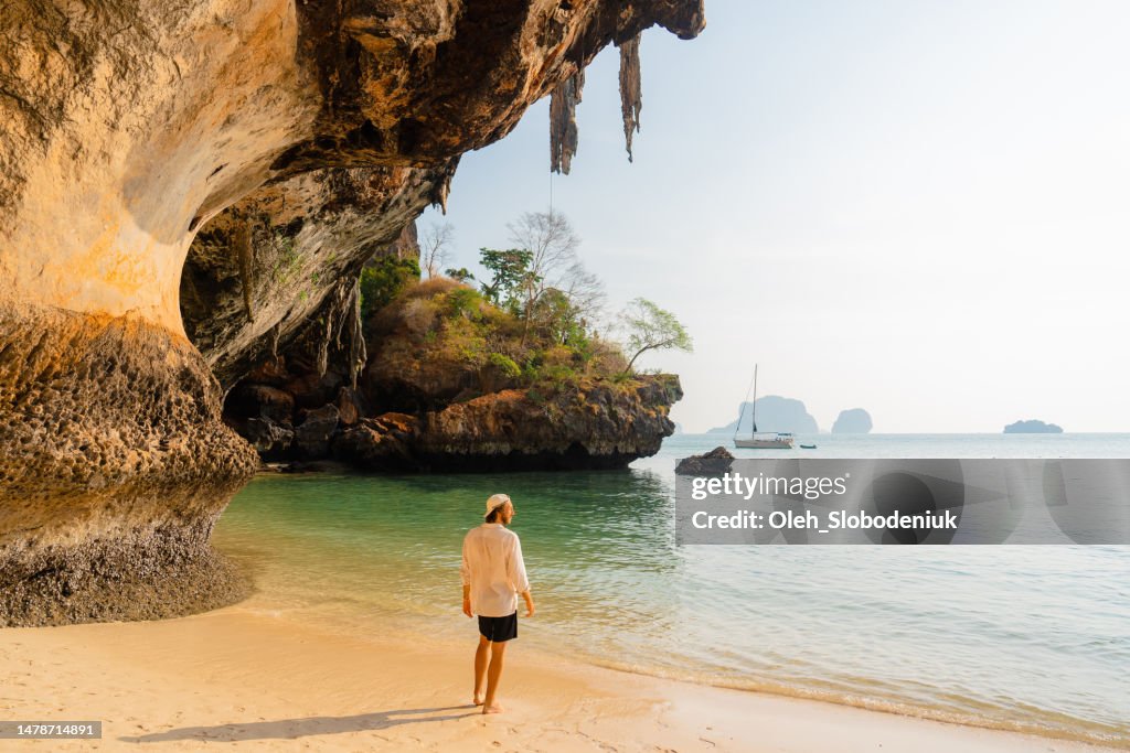 Man walking on Railey beach and looking at stunning scenery