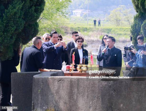 Ma Ying-jeou, former chairman of the Chinese Kuomintang party, and his sisters pay respects to their ancestors at the tomb of his grandfather on...