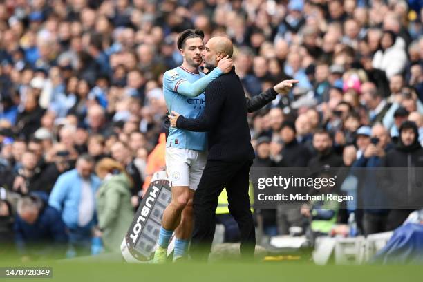 Jack Grealish is embraced by Pep Guardiola, Manager of Manchester City, after being substituted off during the Premier League match between...