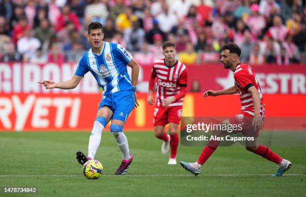 Cesar Montes of RCD Espanyol is put under pressure by Ivan Martin of Girona FC during the LaLiga Santander match between Girona FC and RCD Espanyol...