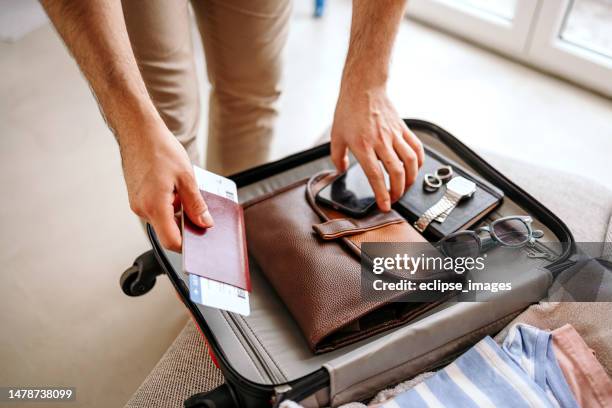 man prepares his luggage for the journey. - travel preparation stock pictures, royalty-free photos & images