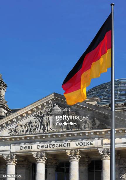 deutscher bundestag - reichstag building with german flag (german parliament building) - berlin, germany - german flag wallpaper stock pictures, royalty-free photos & images