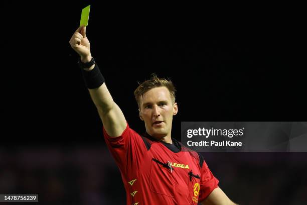 Referee Daniel Cook shows Matthew Millar of Macarthur FC a yellow card during the round 22 A-League Men's match between Perth Glory and Macarthur FC...