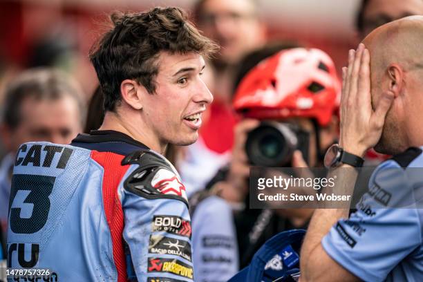 Alex Marquez of Spain and Gresini Racing MotoGP speaks to his mechanic at parc ferme after his pole position during qualifying session of the MotoGP...