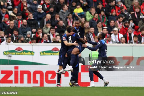 Kimberly Ezekwem of Sport-Club Freiburg celebrates with teammates after scoring the team's first goal during the Bundesliga match between Sport-Club...