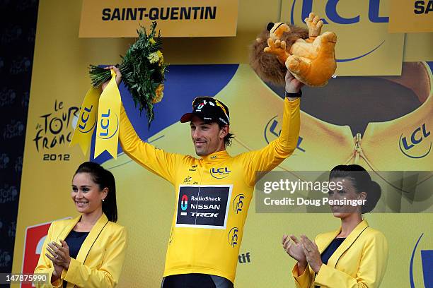 Fabian Cancellara of Switzerland riding for Radioshack-Nissan takes the podium after defending the race leader's yellow jersey during stage five of...