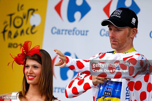 Michael Morkov of Denmark riding for Team Saxo Bank-Tinkoff Bank takes the podium after he retiained the king of the mountains olka dot jersey during...