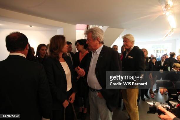 Francois Hollande, Valerie Trierweiler and Alain Delon attend the opening of the exhibition of Florence Cassez, the French citizen emprisoned in...