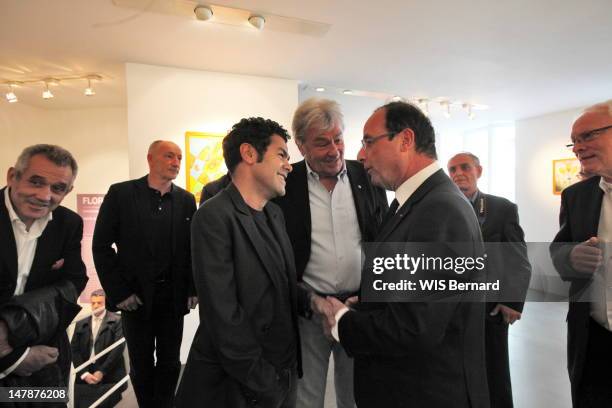 Jamel Debbouze, Alain Delon and French President Francois Hollande attend the opening of the exhibition of Florence Cassez, the French citizen...
