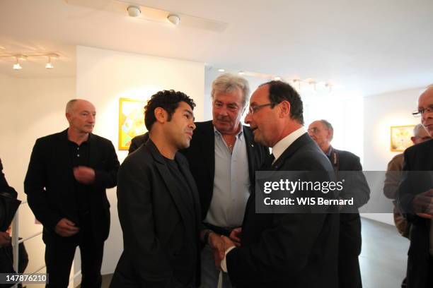 Jamel Debbouze, Alain Delon and French President Francois Hollande attend the opening of the exhibition of Florence Cassez, the French citizen...