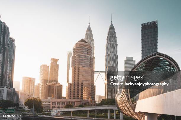 petronas twin towers at sunset - kuala lumpur twin tower stock pictures, royalty-free photos & images