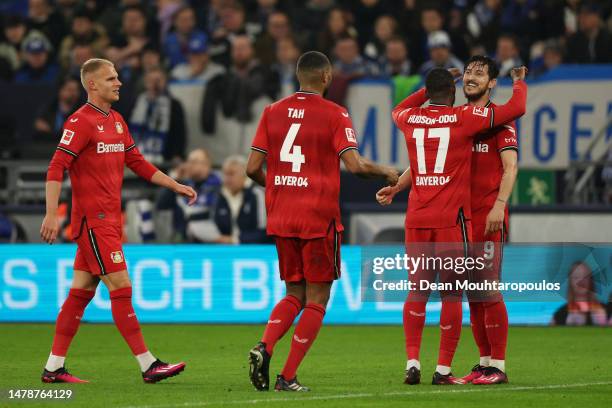 Sardar Azmoun of Bayer 04 Leverkusen celebrates with teammates after scoring the team's third goal during the Bundesliga match between FC Schalke 04...