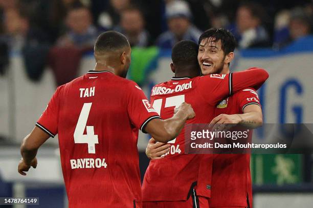 Sardar Azmoun of Bayer 04 Leverkusen celebrates with teammates after scoring the team's third goal during the Bundesliga match between FC Schalke 04...