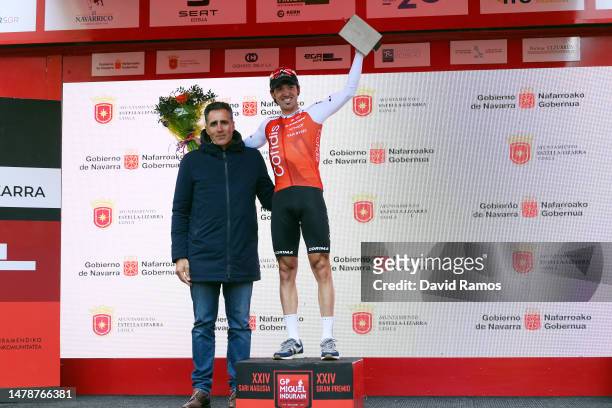 Miguel Indurain of Spain Ex Pro-Cyclist hands over the trophy to race winner Ion Izaguirre of Spain and Team Cofidis at the podium ceremony during...
