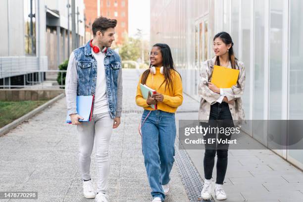 african american girl walking together with student friends around university campus - study abroad stock pictures, royalty-free photos & images