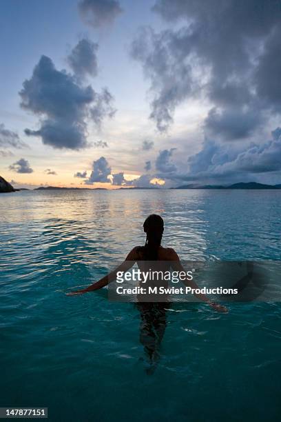 serene night swimming - waist deep in water stock pictures, royalty-free photos & images