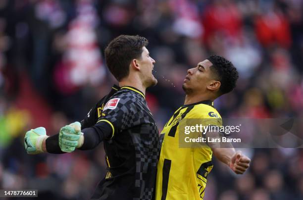 Gregor Kobel of Borussia Dortmund interacts teammate Jude Bellingham prior to during the Bundesliga match between FC Bayern München and Borussia...