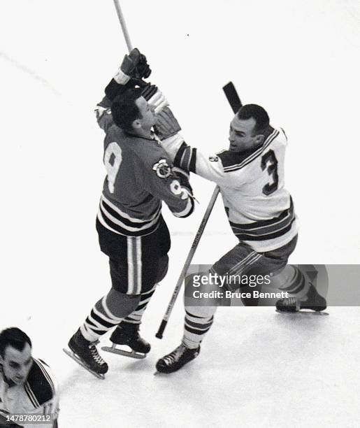 Bronco Horvath of the Chicago Blackhawks goes against Harry Howell of the New York Rangers skates in NHL action in 1961 in New York, New York.