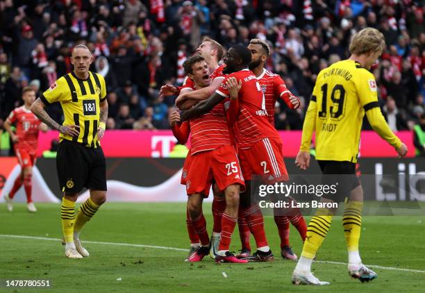 Thomas Mueller of FC Bayern Munich celebrates with teammates after scoring the team's second goal during the Bundesliga match between FC Bayern...