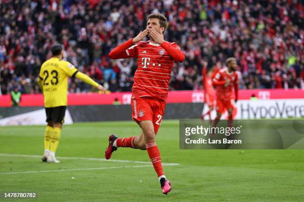 Thomas Mueller of FC Bayern Munich celebrates after scoring the team's third goal during the Bundesliga match between FC Bayern München and Borussia...