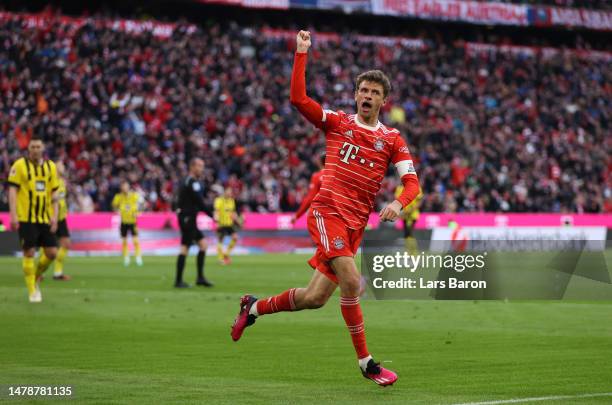 Thomas Mueller of FC Bayern Munich celebrates after scoring the team's third goal during the Bundesliga match between FC Bayern München and Borussia...