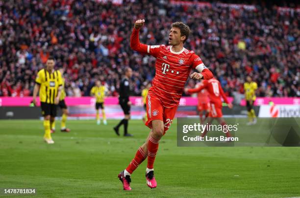 Thomas Mueller of FC Bayern Munich celebrates after scoring the team's third goal during the Bundesliga match between FC Bayern München and Borussia...