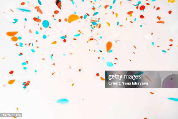 colorful and bright confetti abstract background for celebratory concepts - exploding confetti stock pictures, royalty-free photos & images