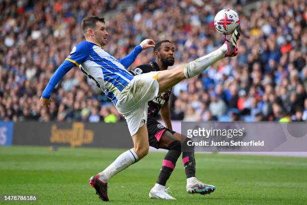 Pascal Gross of Brighton & Hove Albion on the ball whilst under pressure from Rico Henry of Brentford during the Premier League match between...