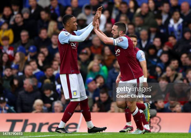 John McGinn of Aston Villa celebrates with teammate Ezri Konsa after scoring the team's second goal during the Premier League match between Chelsea...