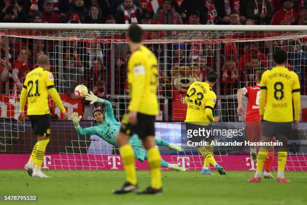 Emre Can of Borussia Dortmund scores the team's first goal via a penalty against Yann Sommer of FC Bayern Munich during the Bundesliga match between...