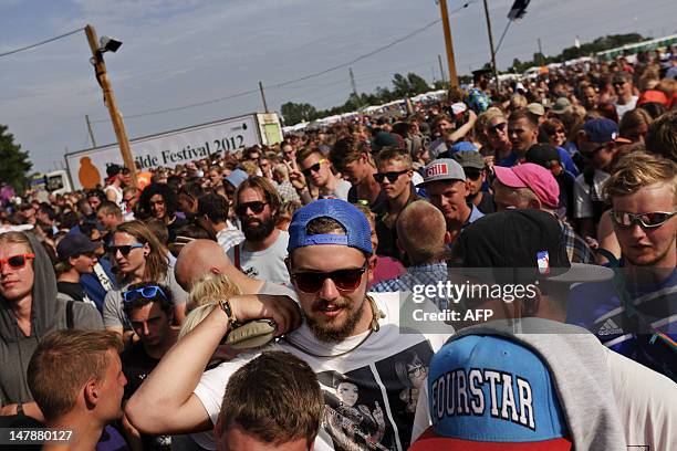 Festival goers run arrive in the festival area, as the gates of the annual Roskilde Festival open in Roskilde, on July 5, 2012. The festival runs...