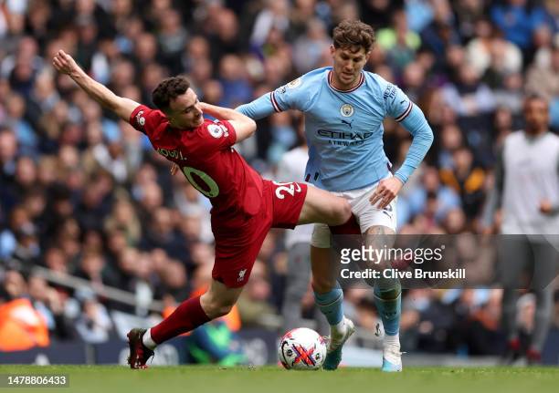 John Stones of Manchester City and Diogo Jota of Liverpool battle for the ball during the Premier League match between Manchester City and Liverpool...