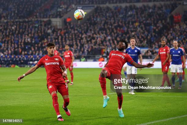 Edmond Tapsoba of Bayer 04 Leverkusen clears the ball during the Bundesliga match between FC Schalke 04 and Bayer 04 Leverkusen at Veltins-Arena on...
