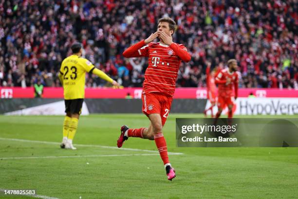 Thomas Mueller of FC Bayern Munich celebrates after scoring the team's third goal during the Bundesliga match between FC Bayern München and Borussia...