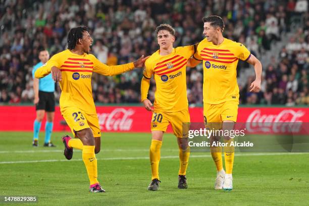 Robert Lewandowski of FC Barcelona celebrates with teammates Jules Kounde and Gavi after scoring the team's third goal during the LaLiga Santander...