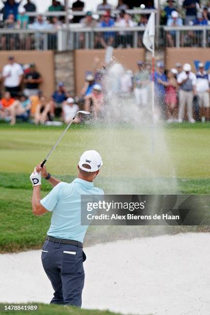 Eric Cole of the United States plays his shot from the bunker on the 16th hole during the third round of the Valero Texas Open at TPC San Antonio on...