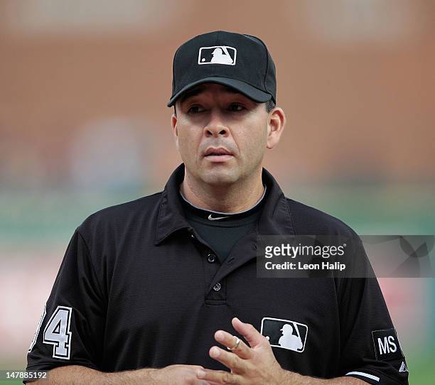 Major League Umpire Angel Campos watches the action prior to the start of the game between the Minnesota Twins and the Detroit Tigers at Comerica...