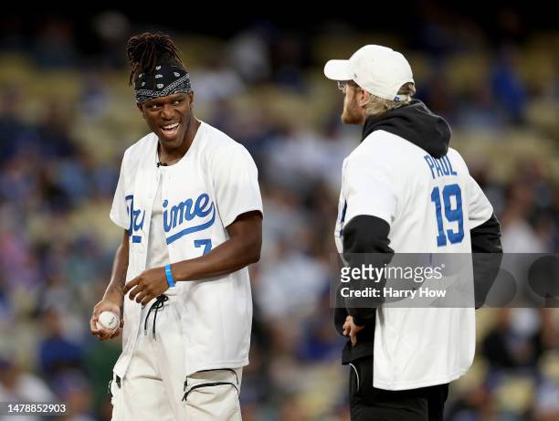 Logan Paul and KSI prepare to throw out a ceremonial first pitch before the game between the Arizona Diamondbacks and the Los Angeles Dodgers at...